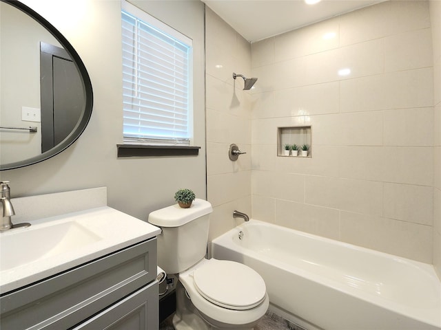 full bathroom featuring vanity, toilet, and tiled shower / bath