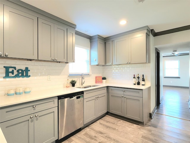 kitchen with gray cabinetry, dishwasher, light hardwood / wood-style flooring, and sink