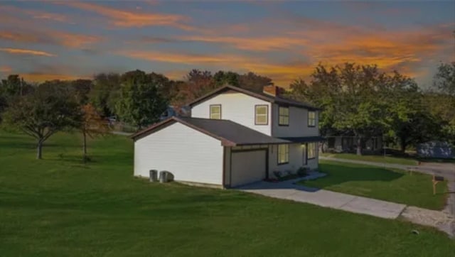 exterior space featuring a lawn and a garage