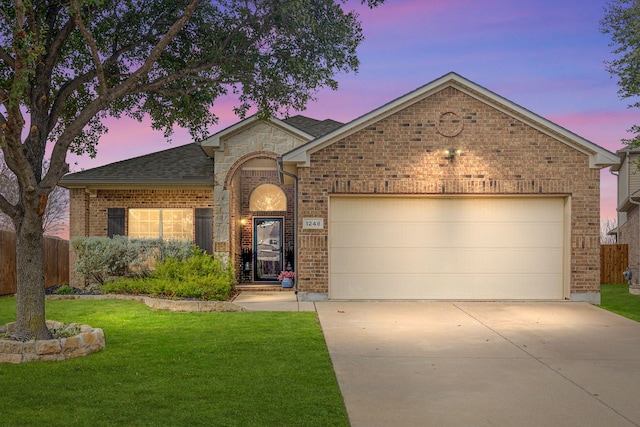 view of front facade with a lawn and a garage