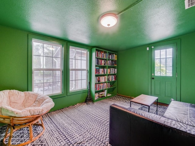 living area with a healthy amount of sunlight and a textured ceiling