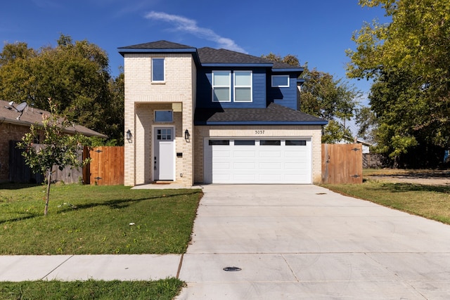 view of front facade with a garage and a front lawn