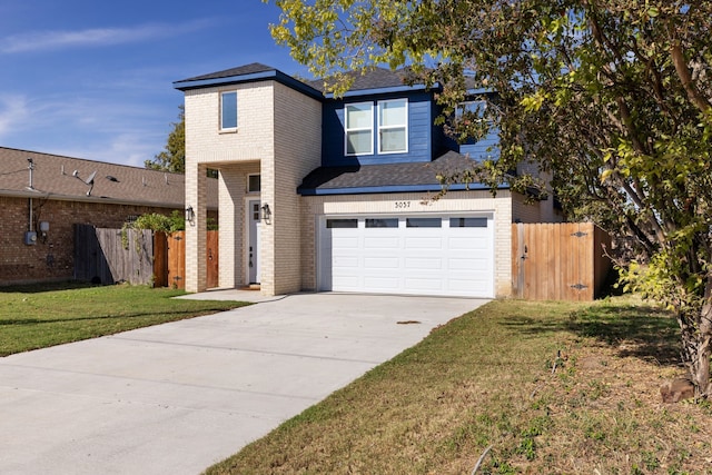 front facade with a garage and a front lawn