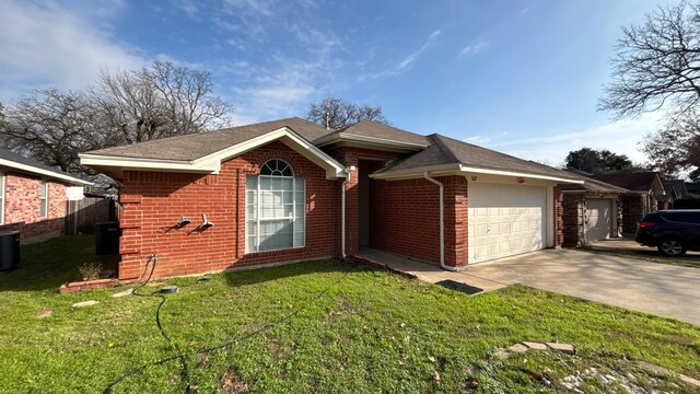 view of exterior entry featuring a yard and a garage