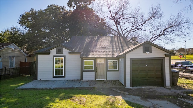 view of front of home featuring a garage and a front lawn