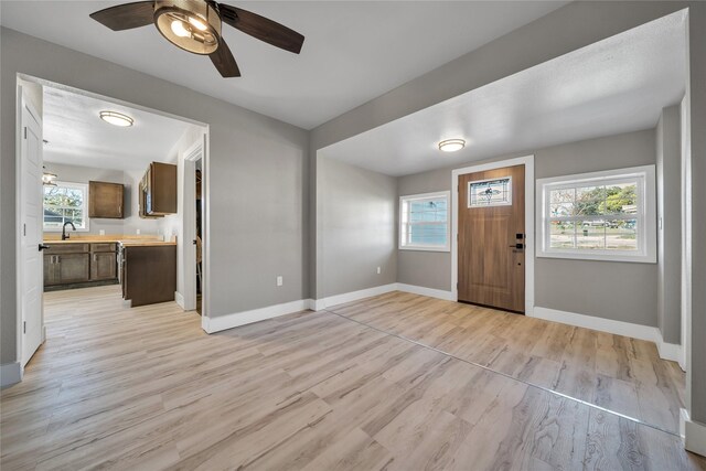 entrance foyer with a wealth of natural light, ceiling fan, and sink