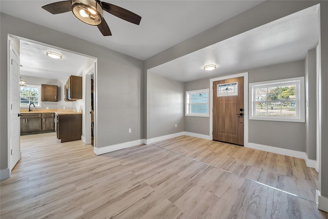 entrance foyer featuring sink, ceiling fan, and light wood-type flooring