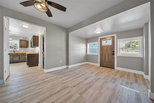 1600 Hemphill Dr, Dallas, TX 75216 - foyer entrance with baseboards, light wood finished floors, and a ceiling fan