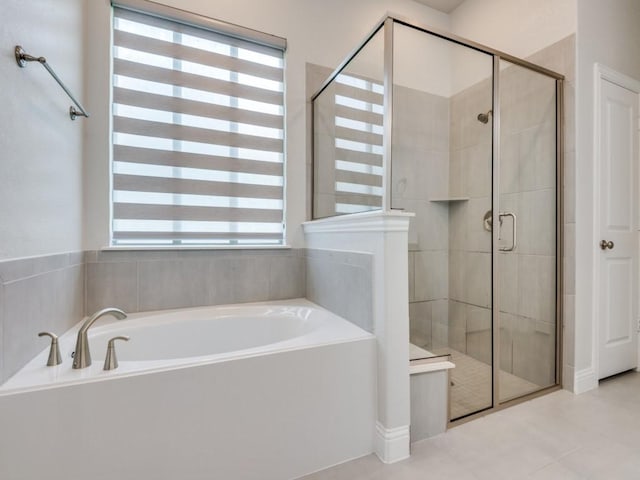 bathroom featuring plus walk in shower and a healthy amount of sunlight