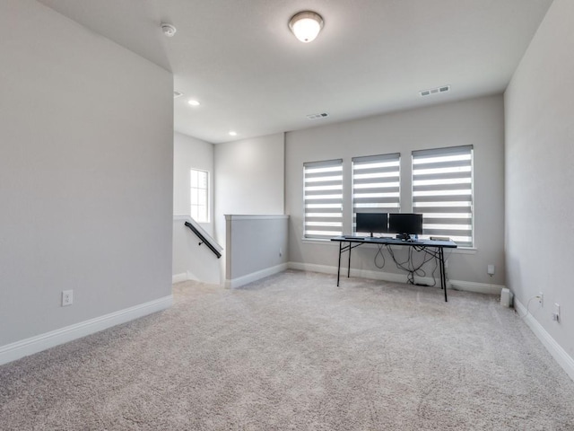 office space with light carpet and a healthy amount of sunlight