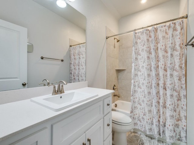 full bathroom with vanity, toilet, and shower / tub combo