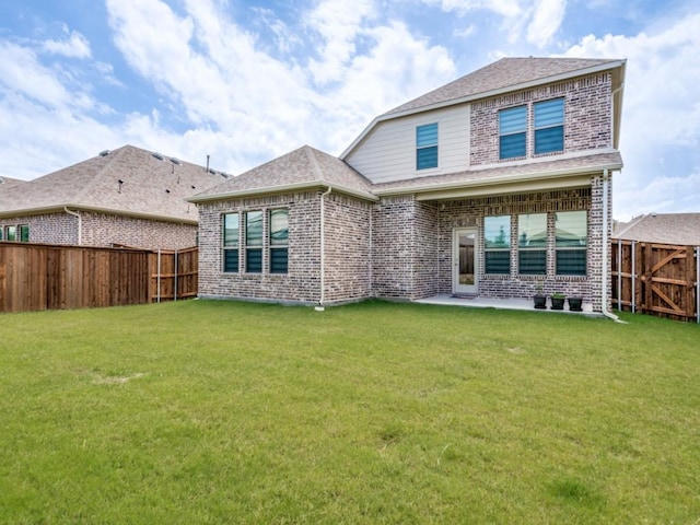 rear view of property with a patio area and a lawn