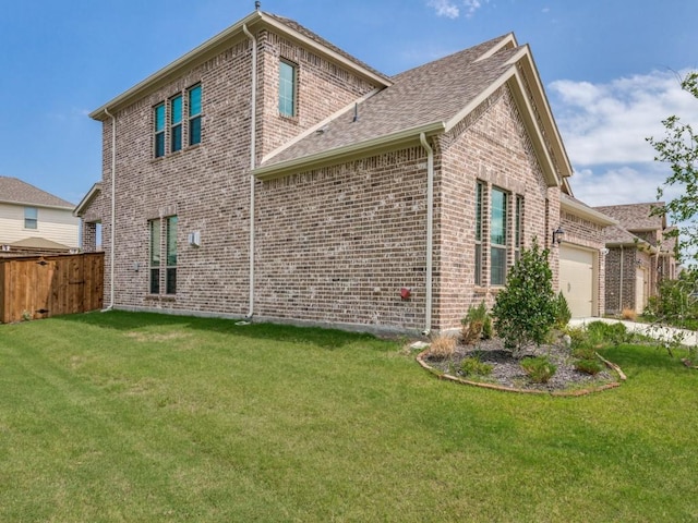 view of side of home featuring a garage and a lawn