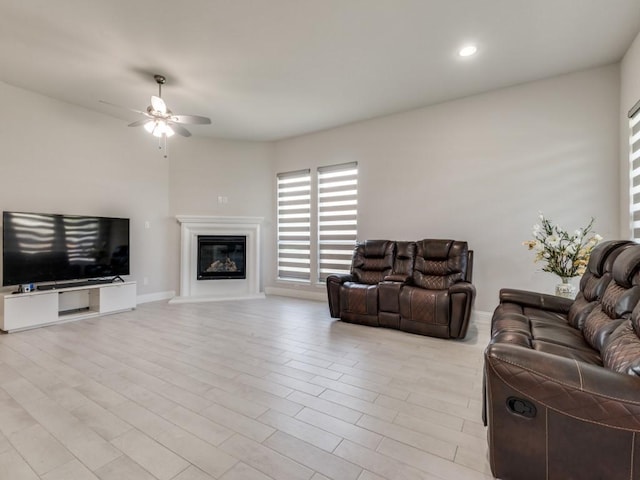 living room featuring light wood-type flooring and ceiling fan