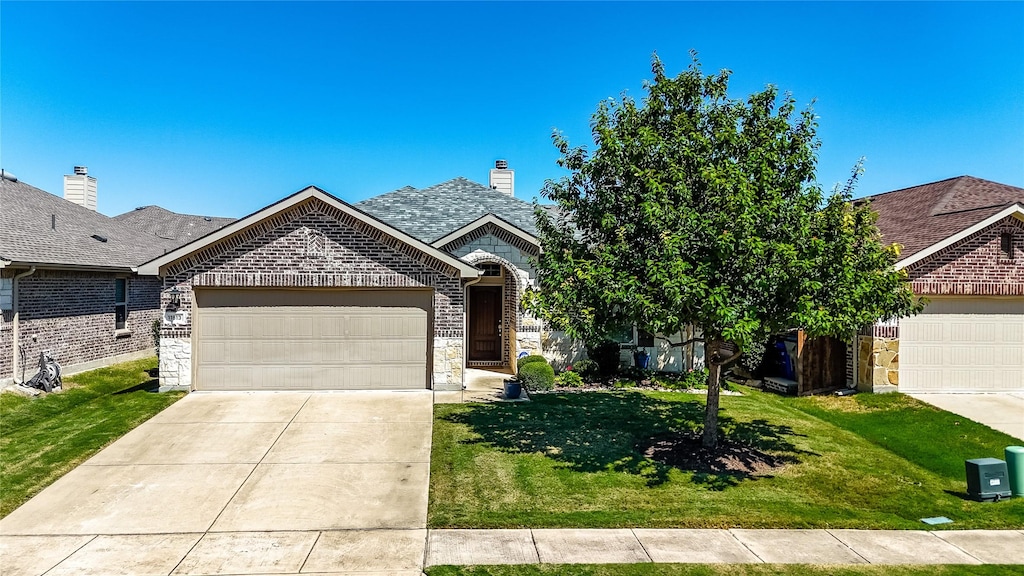 view of front of home featuring a garage and a front lawn