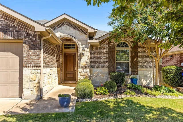 property entrance featuring a yard and a garage