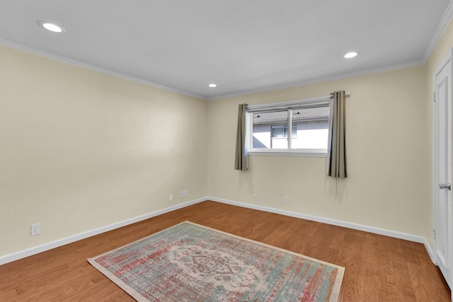 unfurnished room with crown molding and wood-type flooring