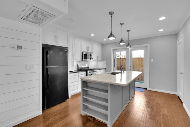 kitchen featuring white cabinetry, sink, hanging light fixtures, a kitchen island with sink, and stainless steel appliances