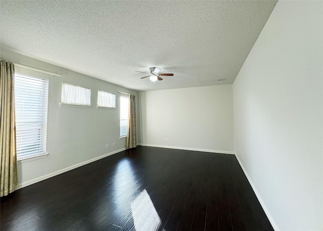 unfurnished room with a textured ceiling, ceiling fan, and dark hardwood / wood-style floors