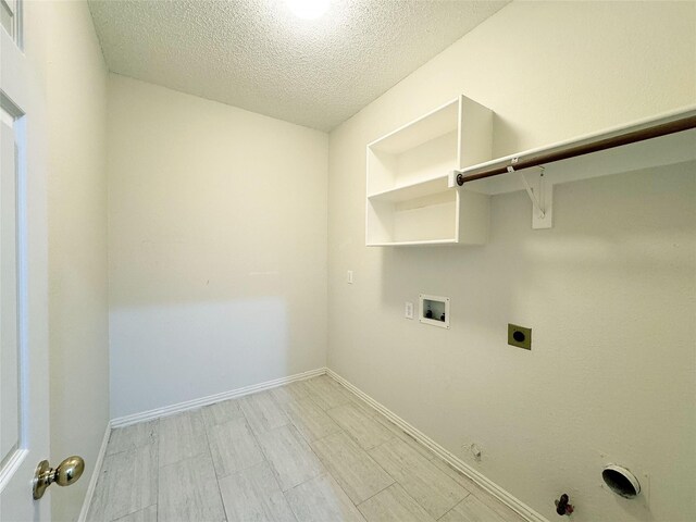 washroom featuring hookup for an electric dryer, gas dryer hookup, a textured ceiling, and washer hookup