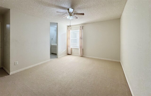 empty room featuring a textured ceiling, light colored carpet, and ceiling fan