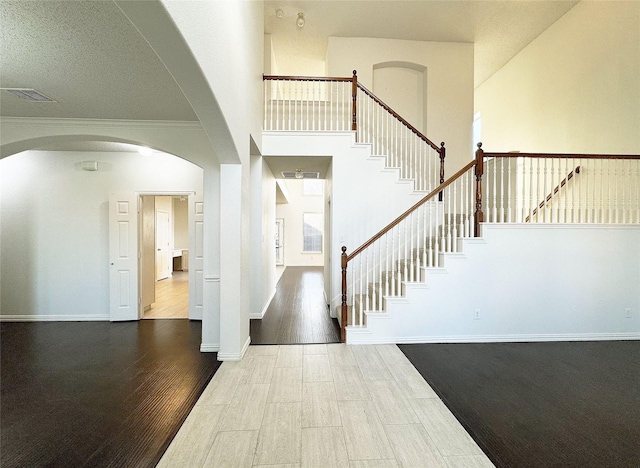 entryway with hardwood / wood-style floors and ornamental molding