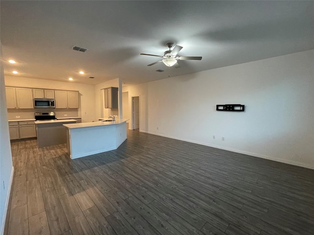 kitchen with sink, a center island, dark hardwood / wood-style floors, ceiling fan, and stove