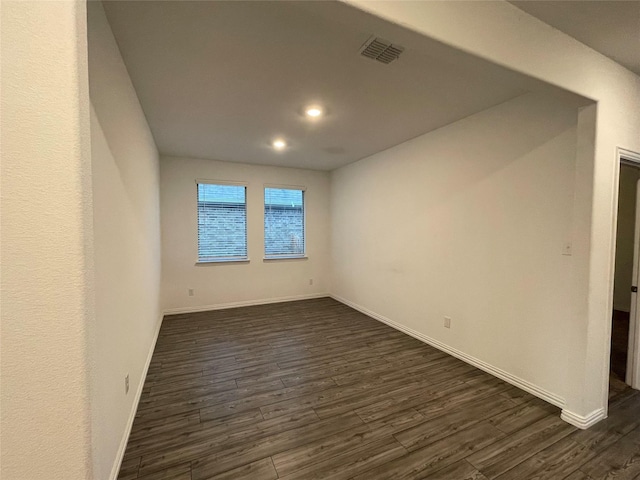 spare room with dark wood-type flooring