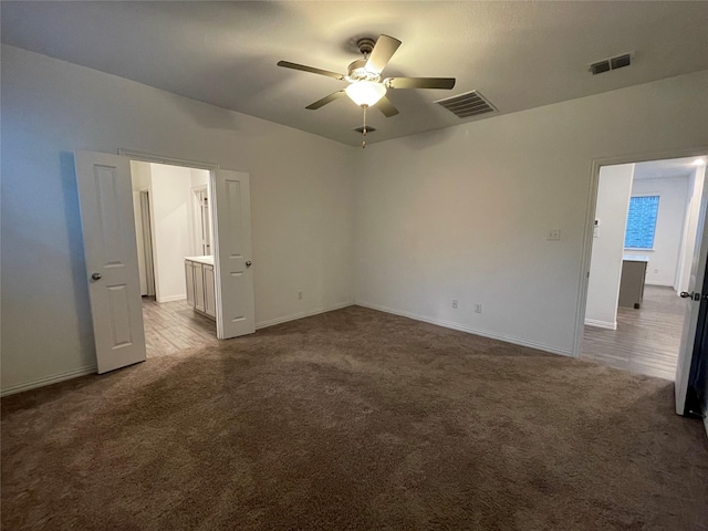 carpeted empty room featuring ceiling fan