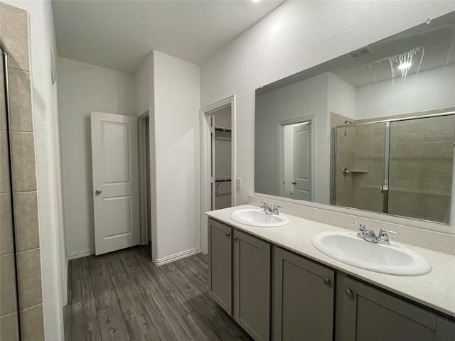 bathroom featuring vanity, hardwood / wood-style flooring, and walk in shower