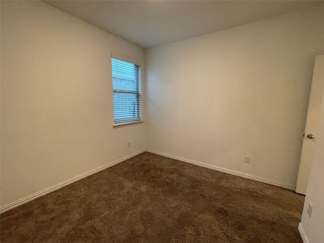 empty room featuring dark carpet