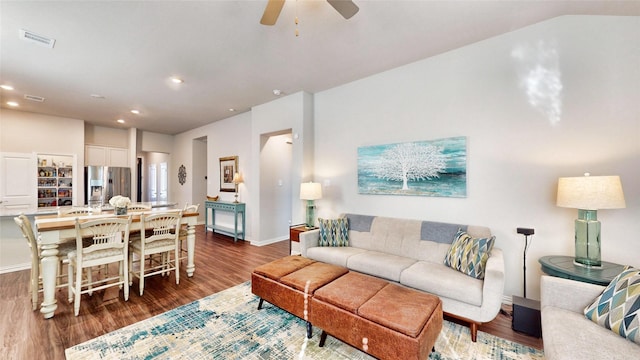 living room featuring dark hardwood / wood-style floors and ceiling fan