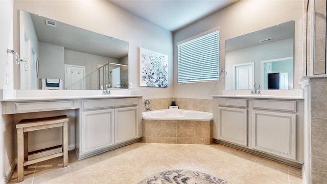 bathroom with tile patterned floors, vanity, and plus walk in shower