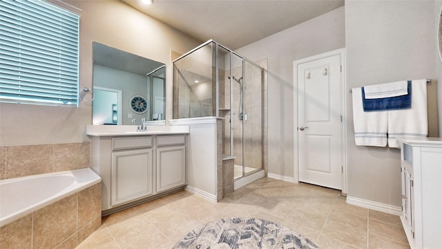 bathroom with tile patterned flooring, shower with separate bathtub, and vanity