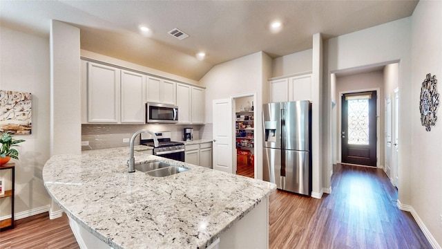 kitchen featuring white cabinetry, kitchen peninsula, sink, and appliances with stainless steel finishes