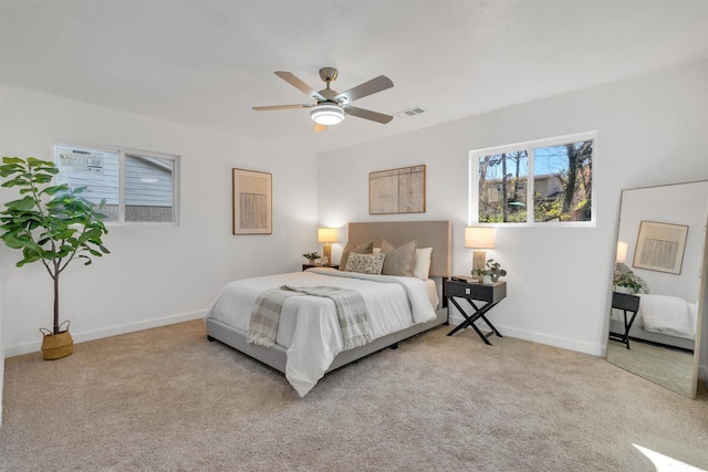 carpeted bedroom with visible vents, ceiling fan, and baseboards