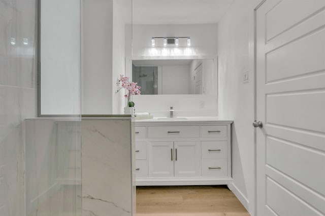 bathroom with hardwood / wood-style floors and vanity