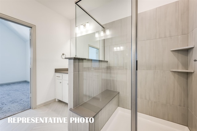 bathroom with vanity and a shower with shower door