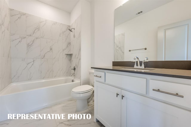 full bathroom featuring vanity, tiled shower / bath combo, and toilet