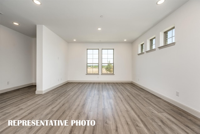 empty room with light hardwood / wood-style flooring