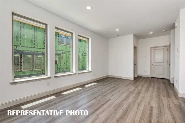 empty room with light hardwood / wood-style floors