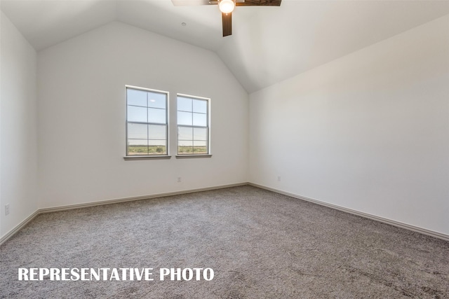 carpeted spare room with ceiling fan and lofted ceiling