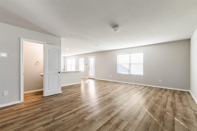 unfurnished living room featuring wood-type flooring