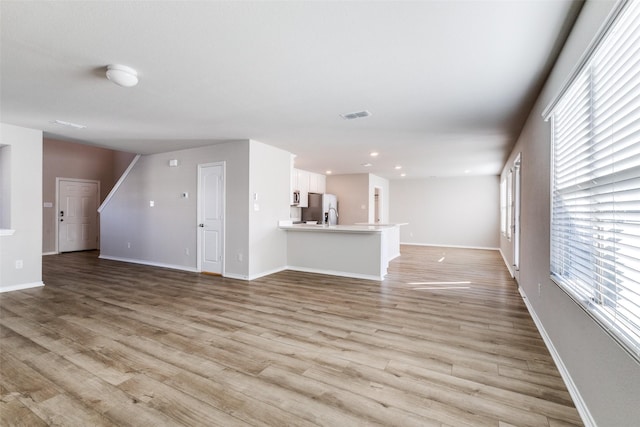 unfurnished living room featuring light wood-type flooring