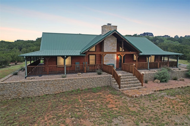 log-style house with covered porch