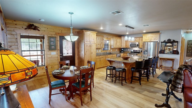 dining room featuring sink and light wood-type flooring