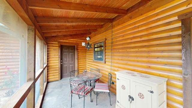 unfurnished sunroom with lofted ceiling with beams and wood ceiling