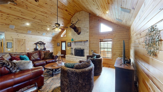 living room featuring wooden walls, ceiling fan, wooden ceiling, and high vaulted ceiling