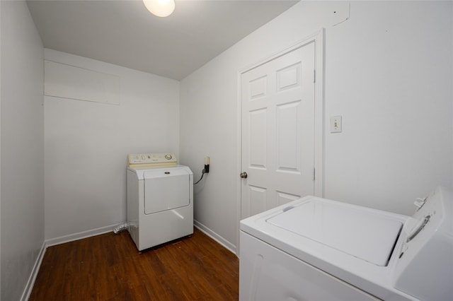 laundry area with washing machine and clothes dryer and dark hardwood / wood-style flooring