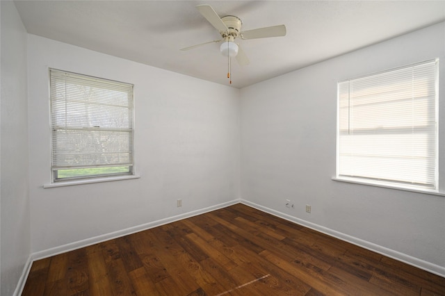 unfurnished room with ceiling fan and dark wood-type flooring